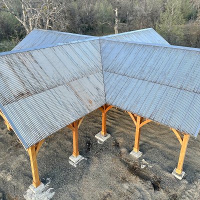 Custom Wood Pavilion (Options: 74' x 74', Douglas-fir, 20-Post Anchor Kit for High-Wind, 10' H Posts, Horizontal Decorative Trims for All Posts, with 5 Ceiling Fan Bases, Transparent Premium Sealant, White Wash for Ceiling). Photo Courtesy of J. Fookes of Elk Creek, CA.