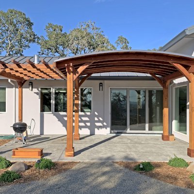 Custom Wood Pavilion Kit with Attached Custom Garden Pergola (Options: 11' L x 16' Arc W [Garden Pergola is 11' L x 8' W], California Redwood, No Post Electrical Wiring Trim, 6-Post Anchor Kit for Concrete, No Ceiling Fan Bases, No Privacy Panels, No Curtain Rods, 10 ft Post Height, Transparent Premium Sealant). Photo Courtesy of K. Jaraczewski of Larkfield-Wikiup, CA.