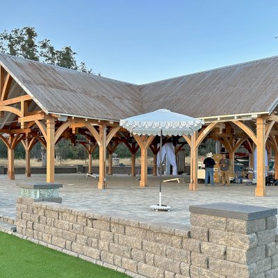 Custom Wood Pavilion (Options: 74' x 74', Douglas-fir, 20-Post Anchor Kit for High-Wind, 10' H Posts, Horizontal Decorative Trims for All Posts, with 5 Ceiling Fan Bases, Transparent Premium Sealant, White Wash for Ceiling). Photo Courtesy of J. Fookes of Elk Creek, CA.