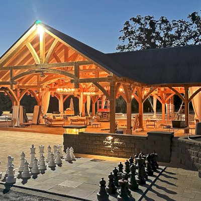 Custom Wood Pavilion (Options: 74' x 74', Douglas-fir, 20-Post Anchor Kit for High-Wind, 10' H Posts, Horizontal Decorative Trims for All Posts, with 5 Ceiling Fan Bases, Transparent Premium Sealant, White Wash for Ceiling). Photo Courtesy of J. Fookes of Elk Creek, CA.