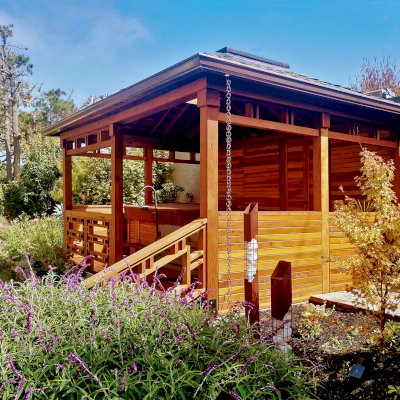 Custom Wood Pavilion Kit (Options: 18' x 14', California Redwood, with Deck, Fixed Wall on Rear Side, Half Walls on Sides, and Custom Railings on Front Side, Transparent Premium Sealant). Photo Courtesy of S. Peletta of Half Moon Bay, CA.