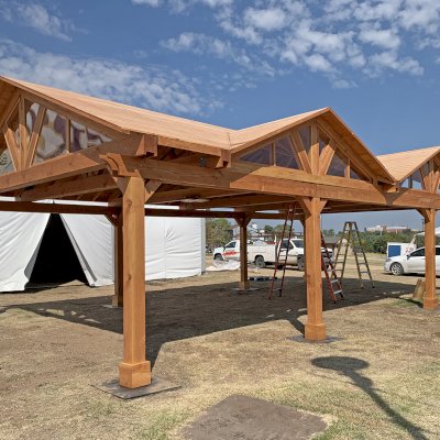 Custom Wood Pavilion Kit (Options: 43 ft L x 23 ft W, Douglas-fir, Transparent Premium Sealant). After installation prior to roofing being added. Polycarbonate enclosure added by custom request. Photo Courtesy of Tulsa, Oklahoma Oktoberfest Team.