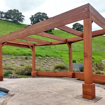 Custom Wooden Pergola (Options: 20' x 12', Mature Redwood, Posts Anchor Kit for High-Wind, Transparent Premium Sealant). Photo Courtesy of D. Ruprecht of Hollister, CA.