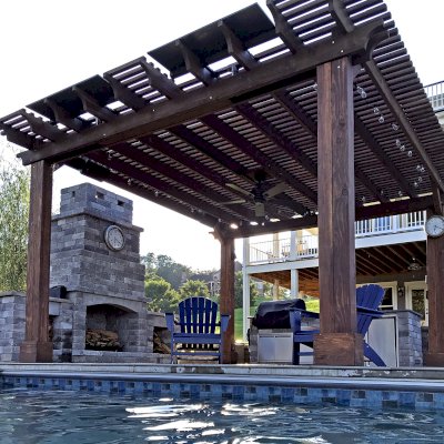 Custom Garden Pergola (Options: 16' L x 16' W, California Redwood, 4-Post Anchor Kit for Concrete, Cherry Stain Premium Sealant). Plumbing was built into the timbers to create a waterfall. Photo Courtesy of D. Hogan of Charlottesville, Virginia.