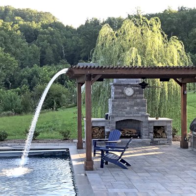 Custom Garden Pergola (Options: 16' L x 16' W, California Redwood, 4-Post Anchor Kit for Concrete, Cherry Stain Premium Sealant). Plumbing was built into the timbers to create a waterfall. Photo Courtesy of D. Hogan of Charlottesville, Virginia.