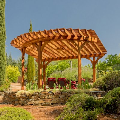Custom Wooden Pergola (Options: 17' L x 17' W, California Redwood, Electrical Wiring Trim for 1 Post, 5-Post Anchor Kit for Concrete, No Ceiling Fan Base, No Privacy Panels, No Curtain Rods, Transparent Premium Sealant). Photo Courtesy of K. Drahmann of El Dorado Hills, CA.