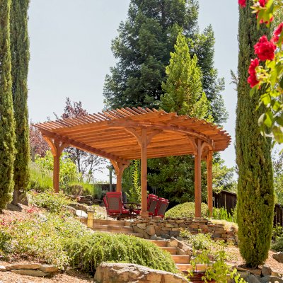 Custom Wooden Pergola (Options: 17' L x 17' W, California Redwood, Electrical Wiring Trim for 1 Post, 5-Post Anchor Kit for Concrete, No Ceiling Fan Base, No Privacy Panels, No Curtain Rods, Transparent Premium Sealant). Photo Courtesy of K. Drahmann of El Dorado Hills, CA.