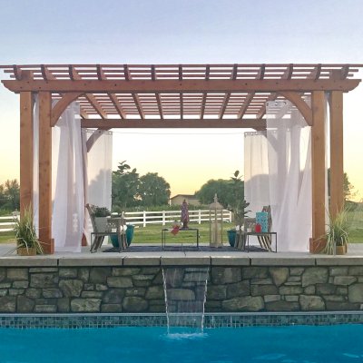Custom Garden Pergola (Options: 20' x 14', Douglas-fir, Slats at 12" On Center and Rafters at 18" On Center, Open Roof, 10' H Posts, 8x8 Dual Posts and 3x8 Roof Timbers by Custom Request, Post Anchor Kit for Concrete, Transparent Premium Sealant). Photo Courtesy of K. Copeland of Sunnyside, Washington.
