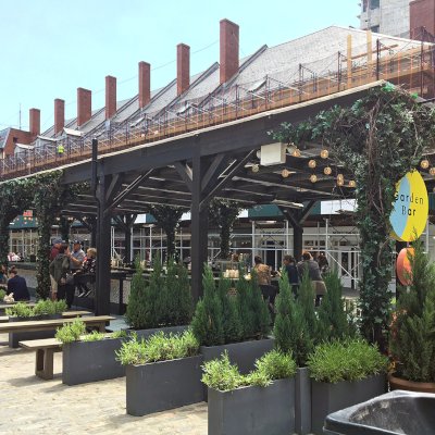 Custom Wooden Pergola (Options: 82' L x 16' W, Douglas-fir, Open Roof with Rafters at 18", with Transparent Rain Guard, 12-Post Anchor Kit, No Ceiling Fan Base, 12' Post Height, Custom Black Paint). This pergola is part of the giant popup beer hall at the Southside Seaport in downtown Manhattan from May to Oct 2017: https://www.timeout.com/newyork/blog/a-giant-pop-up-beer-hall-is-opening-at-south-street-seaport-this-summer-032417