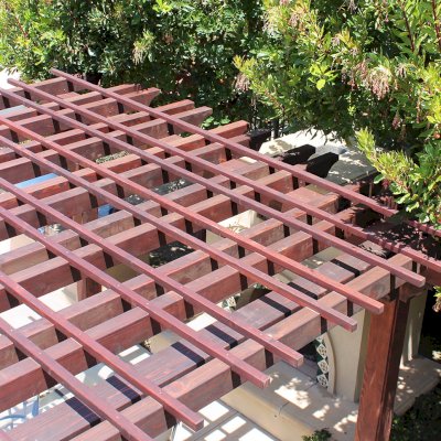 Custom Wooden Fat Timber Pergola (Options: 15' L x 15' W, Old Growth Redwood, Include Wiring Trim for 1 Post, Open Roof with Slats at 18" Rafters at 18" Roof Support Timbers, 4-Post Anchor Kit for Concrete, No Ceiling Fan Base, No Privacy Panels, No Curtain Rods, 11ft 6in Post Height square to outside corners, Include enough overhang to go to full 15 ft square roof size., Coffee-Stain Premium Sealant). Photo Courtesy of Bruce K. of Newport Coast, CA.