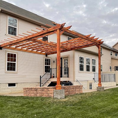 Custom Attached Wooden Pergola (Options: 18' W x 22' L, Mosaic Redwood, 12' H Posts, Transparent Premium Sealant). Photo Courtesy of Anthony Campanale of Waldorf, MD.