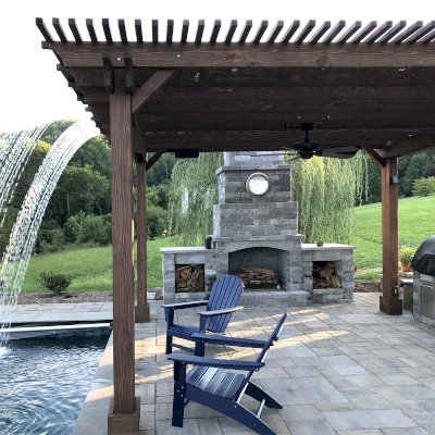 Custom Garden Pergola (Options: 16' L x 16' W, California Redwood, 4-Post Anchor Kit for Concrete, Cherry Stain Premium Sealant). Plumbing was built into the timbers to create a waterfall. Photo Courtesy of D. Hogan of Charlottesville, Virginia.