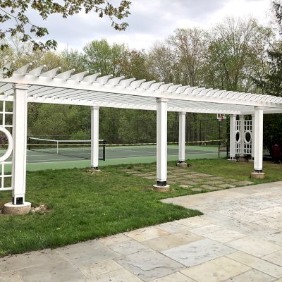 Custom Wooden Fat Timber Pergola (Options: 40' x 18', California Redwood, Posts Anchor Kit for High-Wind, Custom Trellis Between Corner Posts, Off-White Oil-Based Primer). Photo Courtesy of L. Hascoe of Greenwich, CT. Custom copper caps atop all posts.