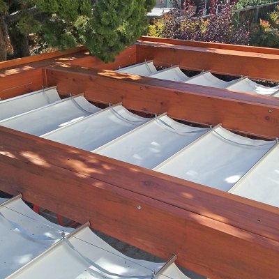 Custom Wooden Fat Timber Pergola (Options: 20' L, 16' W, Old-Growth Redwood, 4 Electrical Wiring Trims, with 2 3/4" x 11 1/4" Roof Timbers and 11 1/4" x 11 1/4" Posts, 4-Post Anchor Kit for High-Wind, No Privacy Panels, Curtain Rods on 4 sides, 10' Post Height, Transparent Premium Sealant). Retractable Canopy designed in cooperation with Infinity Canopy of Los Angeles, CA (www.infinitycanopy.com). Once you have your design finalized, you can forward your drawings to Infinity to add the perfect retractable canopy solution for maximum shade versatility! Photo Courtesy of Darren & Elva Linscott of San Jose, CA.