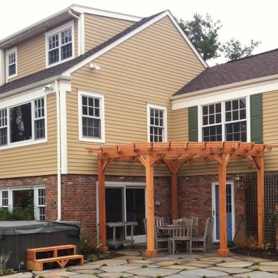 Custom Wooden Pergola (Options: 16' L, 14' W, Mature Redwood, No Electrical Wiring Trim, Open Roof with Slats at 18", Rafters at 18", Lengthwise Roof Support Timbers, 4-Post Anchor Kit for Stone, No Privacy Panels, No Curtain Rods, 9ft Post Height, Transparent Premium Sealant ). Photo Courtesy of Deborah Pasik of Morristown, New Jersey.