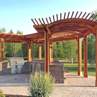 Custom Wooden Pergola (Options: 33' L, 11'-6" W, California Redwood, 1 Electrical Wiring Trim, 10-Post Anchor Kit for Concrete, No Privacy Panels, No Curtain Rods, 9' Post Height, Transparent Premium Sealant). Photo Courtesy of D. Pollock of Baldwinsville, NY.