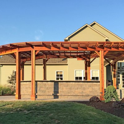 Custom Wooden Pergola (Options: 33' L, 11'-6" W, California Redwood, 1 Electrical Wiring Trim, 10-Post Anchor Kit for Concrete, No Privacy Panels, No Curtain Rods, 9' Post Height, Transparent Premium Sealant). Photo Courtesy of D. Pollock of Baldwinsville, NY.