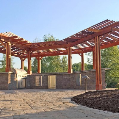 Custom Wooden Pergola (Options: 33' L, 11'-6" W, California Redwood, 1 Electrical Wiring Trim, 10-Post Anchor Kit for Concrete, No Privacy Panels, No Curtain Rods, 9' Post Height, Transparent Premium Sealant). Photo Courtesy of D. Pollock of Baldwinsville, NY.
