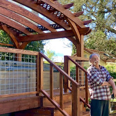 Custom Arched Pergola Kits (Options: 12' L x 22' Arc W, Douglas-fir, Unattached, Electrical Wiring Trim Kit for 1 Post, Arched Roof with Lattice Panels and Acrylic Sheets Centered, 4 Post Anchor Kit for Stone, with 8 x 8 Posts by Custom Request, No Ceiling Fan Base, No Privacy Panels, 1 Curtain Rod, 9' Post Height, Coffee-Stain Premium Sealant) with Custom Deck and Stairs by Custom Request. Photo Courtesy of Steve & Heidi Jones of Windsor, CA.