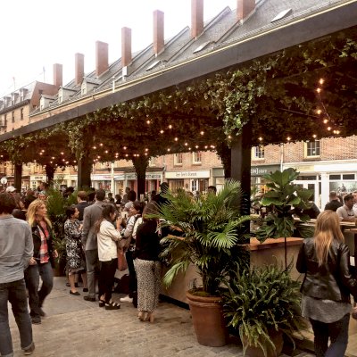 Custom Wooden Pergola (Options: 82' L x 16' W, Douglas-fir, Open Roof with Rafters at 18", with Transparent Rain Guard, 12-Post Anchor Kit, No Ceiling Fan Base, 12' Post Height, Custom Black Paint). This pergola is part of the giant popup beer hall at the Southside Seaport in downtown Manhattan from May to Oct 2017: https://www.timeout.com/newyork/blog/a-giant-pop-up-beer-hall-is-opening-at-south-street-seaport-this-summer-032417
