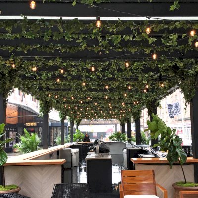 Custom Wooden Pergola (Options: 82' L x 16' W, Douglas-fir, Open Roof with Rafters at 18", with Transparent Rain Guard, 12-Post Anchor Kit, No Ceiling Fan Base, 12' Post Height, Custom Black Paint). This pergola is part of the giant popup beer hall at the Southside Seaport in downtown Manhattan from May to Oct 2017: https://www.timeout.com/newyork/blog/a-giant-pop-up-beer-hall-is-opening-at-south-street-seaport-this-summer-032417