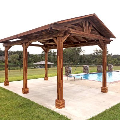 Del Norte Outdoor Kitchen Pavilion (Options: 18' L x 12' W, Mosaic Redwood, 4-Post Anchor Kit for Concrete, 1 Ceiling Fan Base, 2 Electrical Wiring Trim Kits, No Post Decorative Trims, Transparent Premium Sealant). With 5 Posts by Custom Request. Photo Courtesy of A. Bamburg of Natchitoches, Louisiana.