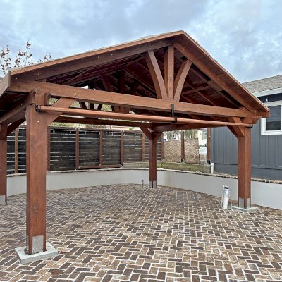 Del Norte Outdoor Kitchen Pavilion (Options: 16' L x 20' W, Douglas-fir, No Privacy Panel, 4-Post Anchor Kit for Concrete, 9' H Posts, 1 Ceiling Fan Base, No Curtain Rod, No Fascia Boards, with 10x10 Posts by Custom Request, Electrical Wiring Trim Kit for 1 Post, Coffee-Stain Premium Sealant). Photo Courtesy of D. Lacau of Napa, CA.