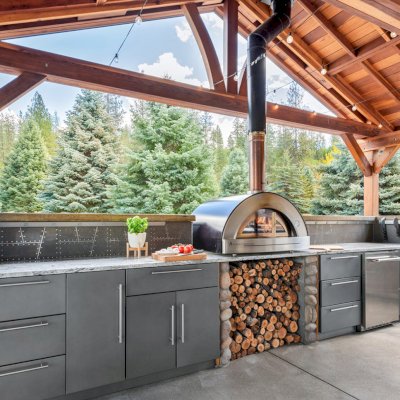 Del Norte Outdoor Kitchen Pavilion (Options: 38.5' L x 18.5' W, California Redwood, No Privacy Panel, Post Anchor Kit for High Wind, 10' H Posts, No Ceiling Fan Base, No Curtain Rod, No Fascia Boards, Transparent Premium Sealant). Photo Courtesy of D. Lemke of Nine Mile Falls, NJ. 