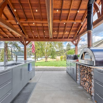 Del Norte Outdoor Kitchen Pavilion (Options: 38.5' L x 18.5' W, California Redwood, No Privacy Panel, Post Anchor Kit for High Wind, 10' H Posts, No Ceiling Fan Base, No Curtain Rod, No Fascia Boards, Transparent Premium Sealant). Photo Courtesy of D. Lemke of Nine Mile Falls, NJ. 