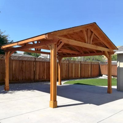 Del Norte Outdoor Kitchen Pavilion (Options: 18' L x 18' W, Douglas-fir, 4-Post Anchor Kit for High-Wind, 1 Ceiling Fan Base, No Electrical Wiring Trim Kit, Vertical Post Decorative Trims, Transparent Premium Sealant). Photo Courtesy of E. Colbert of San Jose, California.