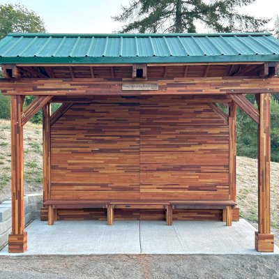 Custom Del Norte Pavilion - Bus Shelter (Options: 14' L x 10' W, Mosaic Redwood, 1 Wall Privacy Panel, Post Anchor Kit for High Wind, 9' H Posts, No Ceiling Fan Base, No Electrical Wiring Trims, No Curtain Rod, Transparent Premium Sealant). Structure Installed at Sehmel Homestead Park in 10123 78th Ave NW, Gig Harbor, WA 98332. , 