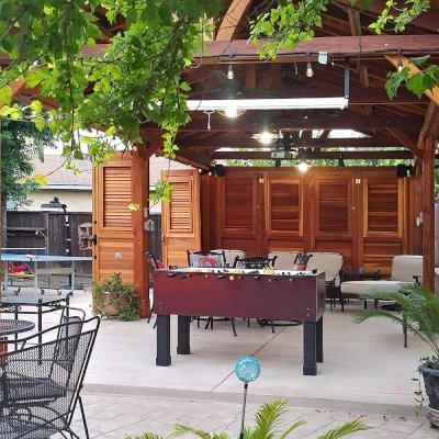 Del Norte Outdoor Kitchen Pavilion (Options: 25' L x 15' W, California Redwood, 6-Post Anchor Kit for Concrete, 4 Ceiling Fan Bases, 2 Electrical Wiring Trim Kits, No Post Decorative Trim, Custom Doors with Louvers & Shutters, Transparent Premium Sealant). Photo Courtesy of J. Gil of San Jose, CA.