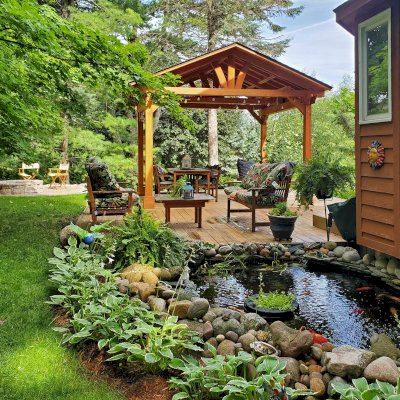 Del Norte Outdoor Kitchen Pavilion (Options: 14' L x 12' W, Douglas-fir, No Privacy Panel, Post Anchor Kit for High Wind, 10' H Posts, No Ceiling Fan Base, No Curtain Rod, Transparent Premium Sealant) with a 6' Jhoola Day Bed Swing. Photo Courtesy of M. Jossens of Traverse City, MI.