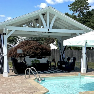 Del Norte Outdoor Kitchen Pavilion (Options: 15' L x 18' W, Mosaic Douglas-Fir, 4-Post Anchor Kit for Concrete, 9.5' H Posts, 1 Ceiling Fan Base, 1 Electrical Wiring Trim Kit, 4 Curtain Rods, White Stain Premium Sealant). Photo Courtesy of S. Leonard of Easton, MA.