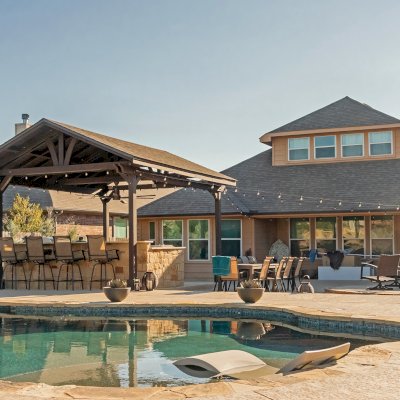 Del Norte Outdoor Kitchen Pavilion (Options: 20' L x 16' W, Mosaic Redwood, 4-Post Kit for Concrete, 1 Ceiling Fan Base, No Electrical Wiring Trim Kit, No Post Decorative Trims, Custom Sealant). Photo Courtesy of S. Oster of Round Rock, TX.