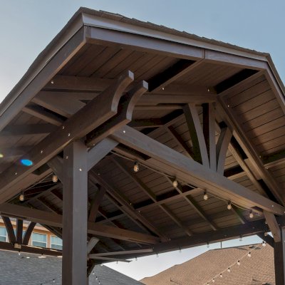 Del Norte Outdoor Kitchen Pavilion (Options: 20' L x 16' W, Mosaic Redwood, 4-Post Kit for Concrete, 1 Ceiling Fan Base, No Electrical Wiring Trim Kit, No Post Decorative Trims, Custom Sealant). Photo Courtesy of S. Oster of Round Rock, TX.