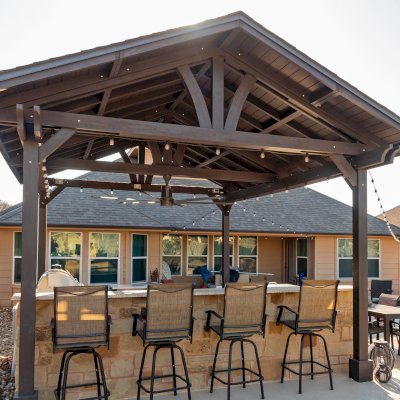Del Norte Outdoor Kitchen Pavilion (Options: 20' L x 16' W, Mosaic Redwood, 4-Post Kit for Concrete, 1 Ceiling Fan Base, No Electrical Wiring Trim Kit, No Post Decorative Trims, Custom Sealant). Photo Courtesy of S. Oster of Round Rock, TX.