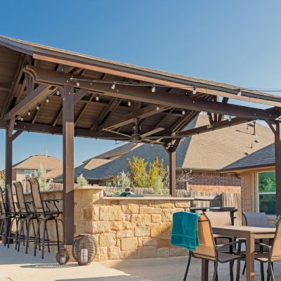 Del Norte Outdoor Kitchen Pavilion (Options: 20' L x 16' W, Mosaic Redwood, 4-Post Kit for Concrete, 1 Ceiling Fan Base, No Electrical Wiring Trim Kit, No Post Decorative Trims, Custom Sealant). Photo Courtesy of S. Oster of Round Rock, TX.
