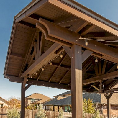 Del Norte Outdoor Kitchen Pavilion (Options: 20' L x 16' W, Mosaic Redwood, 4-Post Kit for Concrete, 1 Ceiling Fan Base, No Electrical Wiring Trim Kit, No Post Decorative Trims, Custom Sealant). Photo Courtesy of S. Oster of Round Rock, TX.