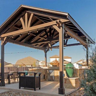 Del Norte Outdoor Kitchen Pavilion (Options: 20' L x 16' W, Mosaic Redwood, 4-Post Kit for Concrete, 1 Ceiling Fan Base, No Electrical Wiring Trim Kit, No Post Decorative Trims, Custom Sealant). Photo Courtesy of S. Oster of Round Rock, TX.