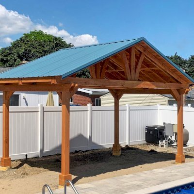 Del Norte Outdoor Kitchen Pavilion (Options: 12' L x 18' W, Douglas-fir, 4-Post Anchor Kit for High-Wind, With 2 Ceiling Fan Base, Electrical Wiring Trim Kit for 2 Posts, Transparent Premium Sealant). Metal Roof Installed by Customer. Photo courtesy of S. Bono of Royal Oak, Michigan.