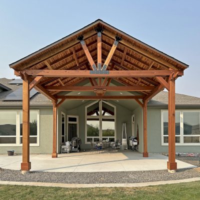Custom Del Norte Outdoor Kitchen Pavilion (Options: 16' L x 20' W, California Redwood with Tongue and Grove Boards in Mosaic Redwood, No Privacy Panel, Post Anchor Kit for High Wind, 12' H Posts, 1 Ceiling Fan Base, No Electrical Wiring Trim, No Curtain Rod, Transparent Premium Sealant). Photo Courtesy of M. Neideffer of Star, ID.