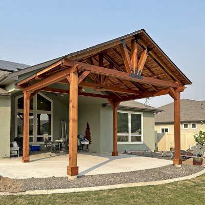 Custom Del Norte Outdoor Kitchen Pavilion (Options: 16' L x 20' W, California Redwood with Tongue and Grove Boards in Mosaic Redwood, No Privacy Panel, Post Anchor Kit for High Wind, 12' H Posts, 1 Ceiling Fan Base, No Electrical Wiring Trim, No Curtain Rod, Transparent Premium Sealant). Photo Courtesy of M. Neideffer of Star, ID.