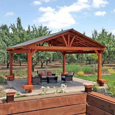 Del Norte Outdoor Kitchen Pavilion (Options: 20' L x 20' W, California Redwood, 4-Post Anchor Kit for Concrete, No Ceiling Fan Bases, No Electrical Wiring Trim Kit, No Post Decorative Trim, Custom Finish [Bare Wood]). Photo Courtesy of D. Greenwood of Escalon, CA.