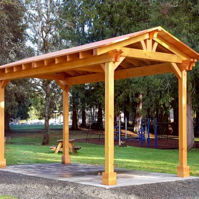 Custom Del Norte Outdoor Kitchen Pavilion (Options: 20' L x 10' W, Douglas-fir, 4-Post Anchor Kit for High-Wind, No Ceiling Fan Base, Transparent Premium Sealant). Larger lumber by custom request. Roofing was still pending when shots taken just after assembly. Photo Courtesy of S. Flanagin of Carnation, WA.
