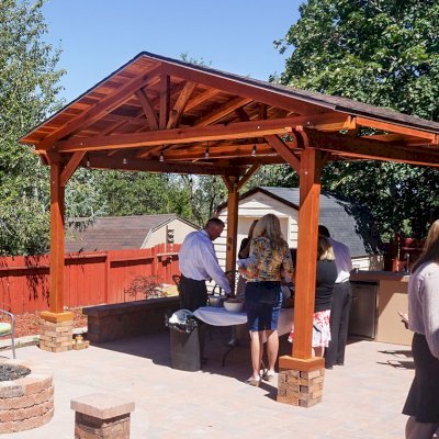 Del Norte Outdoor Kitchen Pavilion (Options: 16' L x 14' W, California Redwood [Mature Redwood Posts], Unattached, 4-Post Anchor Kit for High-Wind, Electrical Wiring Trim for 1 Post, 9.5' Posts, No Ceiling Fan Base, No Privacy Panels, No Curtain Rods, Transparent Premium Sealant). Shingles not Included. Photo Courtesy of K. Hyde of Ogden, Utah.