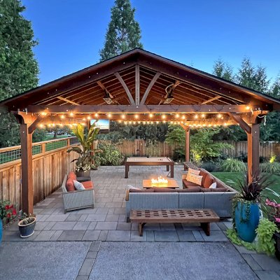 Del Norte Outdoor Kitchen Pavilion (Options: 22' L x 22' W, Mature Redwood, No Privacy Panel, 4-Post Anchor Kit for High-Wind, 9.5' H Posts, 2 Ceiling Fan Bases, 1 Curtain Rod, No Fascia Boards, Electrical Wiring Trim Kit for 2 Posts, Transparent Premium Sealant). Photo Taken 4 Years After Installation. Photo Courtesy of M. Gast of Clackamas, OR.