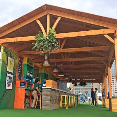 Rio on the Hudson: Olympic Village in NYC. 2 Del Norte Outdoor Kitchen Pavilions (Options: 25' L x 20' W, Douglas-fir, We used 2' x 2' x 2'  Concrete Blocks to Anchor the Structure Because it is a Temporary Installation, Covered the Concrete Blocks with Wooden Boxes, No Ceiling Fan Base, Transparent Premium Sealant). Photo Courtesy of A. Fisher of New York, NY.