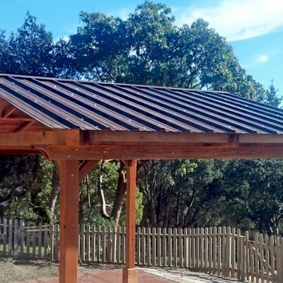 Del Norte Outdoor Kitchen Pavilion (Options: 18' L x 14' W, California Redwood, Unattached, 4-Post Anchor Kit for High-Wind, No Electrical Wiring Trim, 9.5 ft Post Height, No Ceiling Fan Base, No Privacy Panels, No Curtain Rods, Transparent Premium Sealant). Metal Roof by Custom Request. 