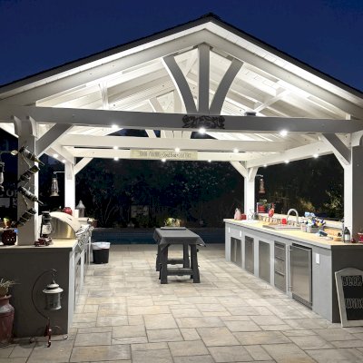 Del Norte Outdoor Kitchen Pavilion (Options: 16' L x 16' W, Douglas-fir, 4-Post Anchor Kit for High-Wind, 2 Fascia Boards, No Ceiling Fan Base, No Electrical Wiring Trim Kit, No Post Decorative Trims, Off-White Oil-Based Primer). Photo Courtesy of J. Felice of Cloverdale, CA.